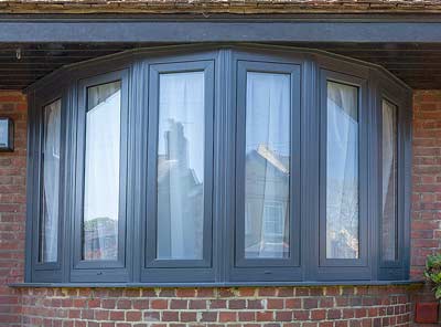 Grey fixed uPVC windows in a bow window